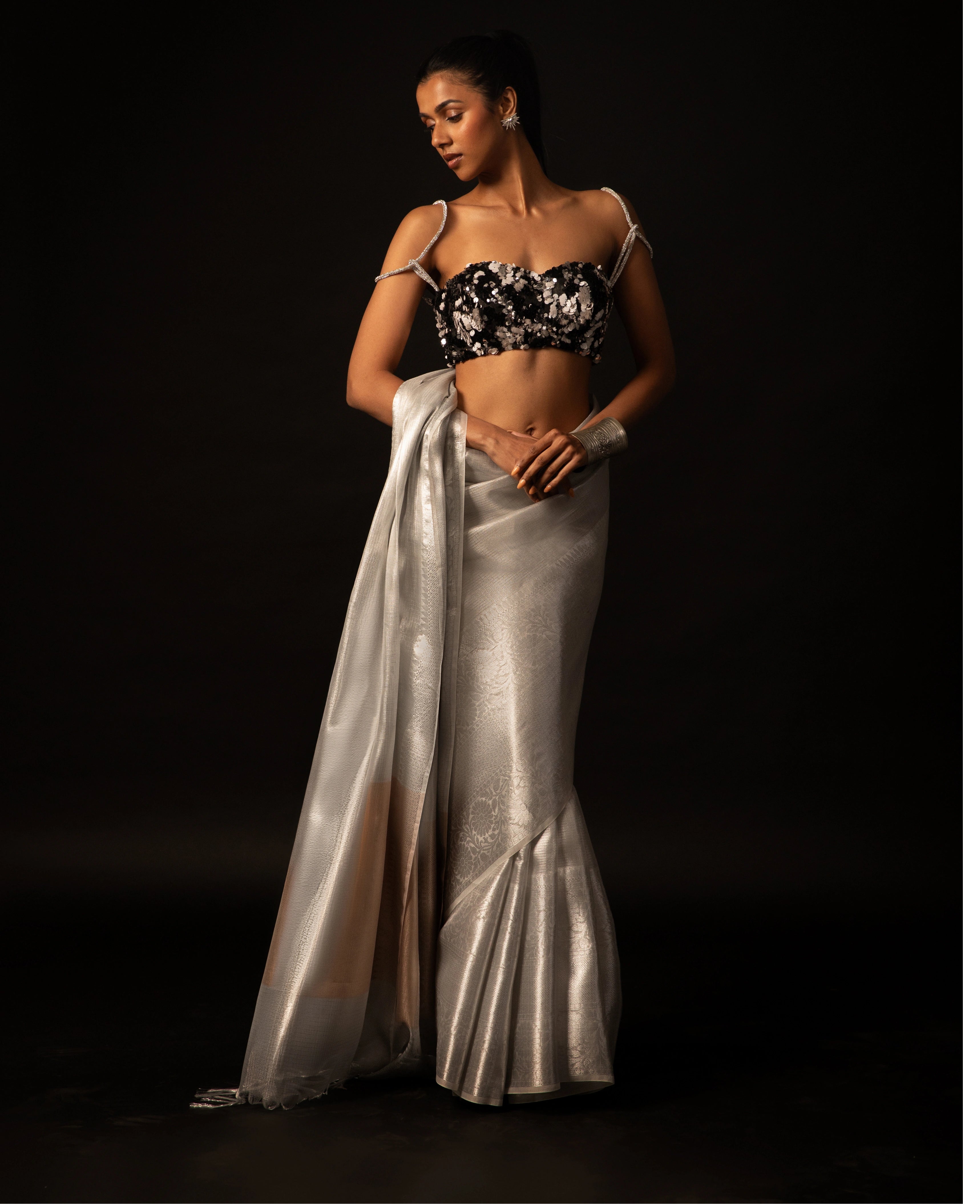 White Banarsi Silk Blend Metallic Tone Saree with Handwoven Border and Black Floral Sequin Blouse
