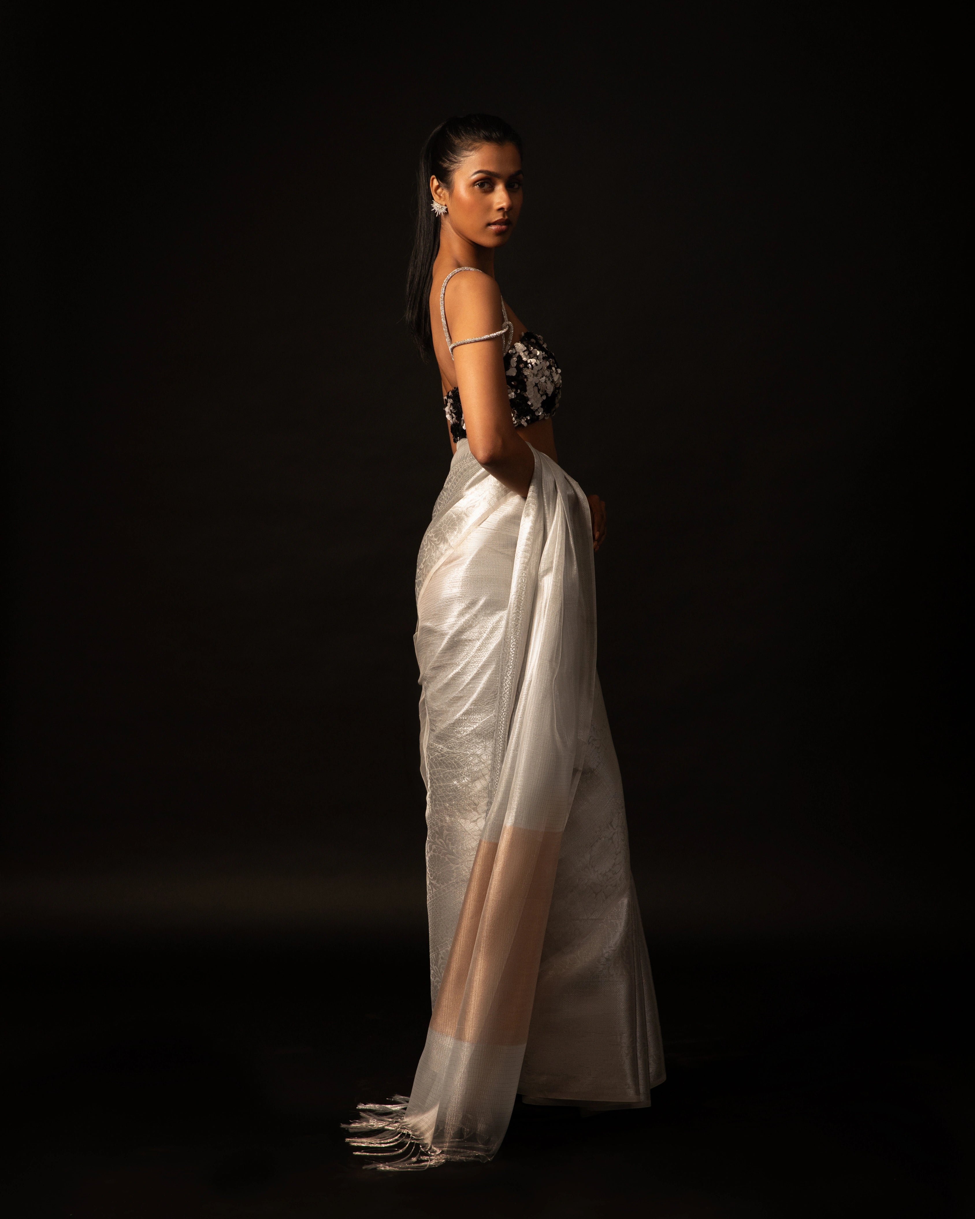 White Banarsi Silk Blend Metallic Tone Saree with Handwoven Border and Black Floral Sequin Blouse