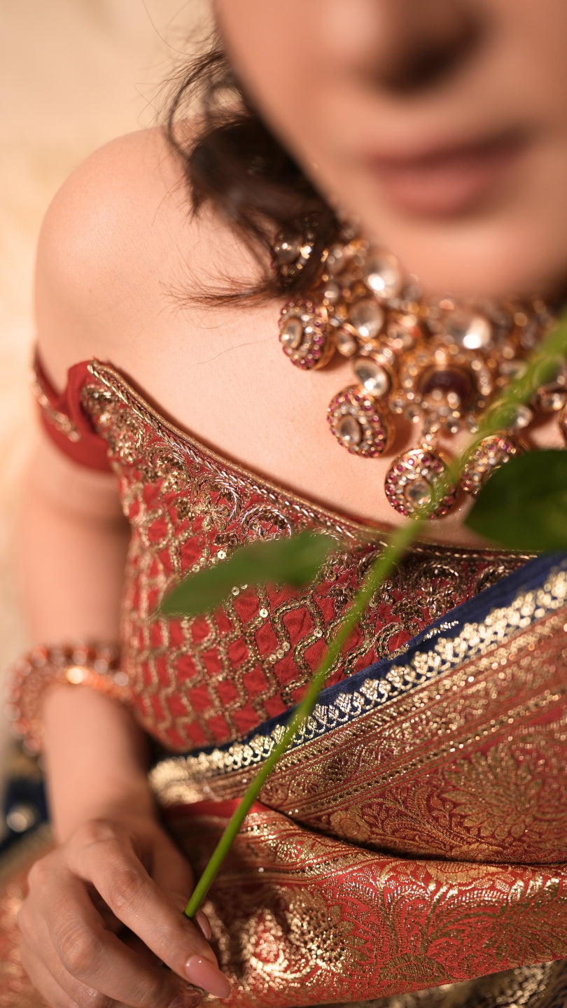 Red and Blue Dual Tone Pure Banarasi Saree with All-Over Floral and Hand Embroidery Border.