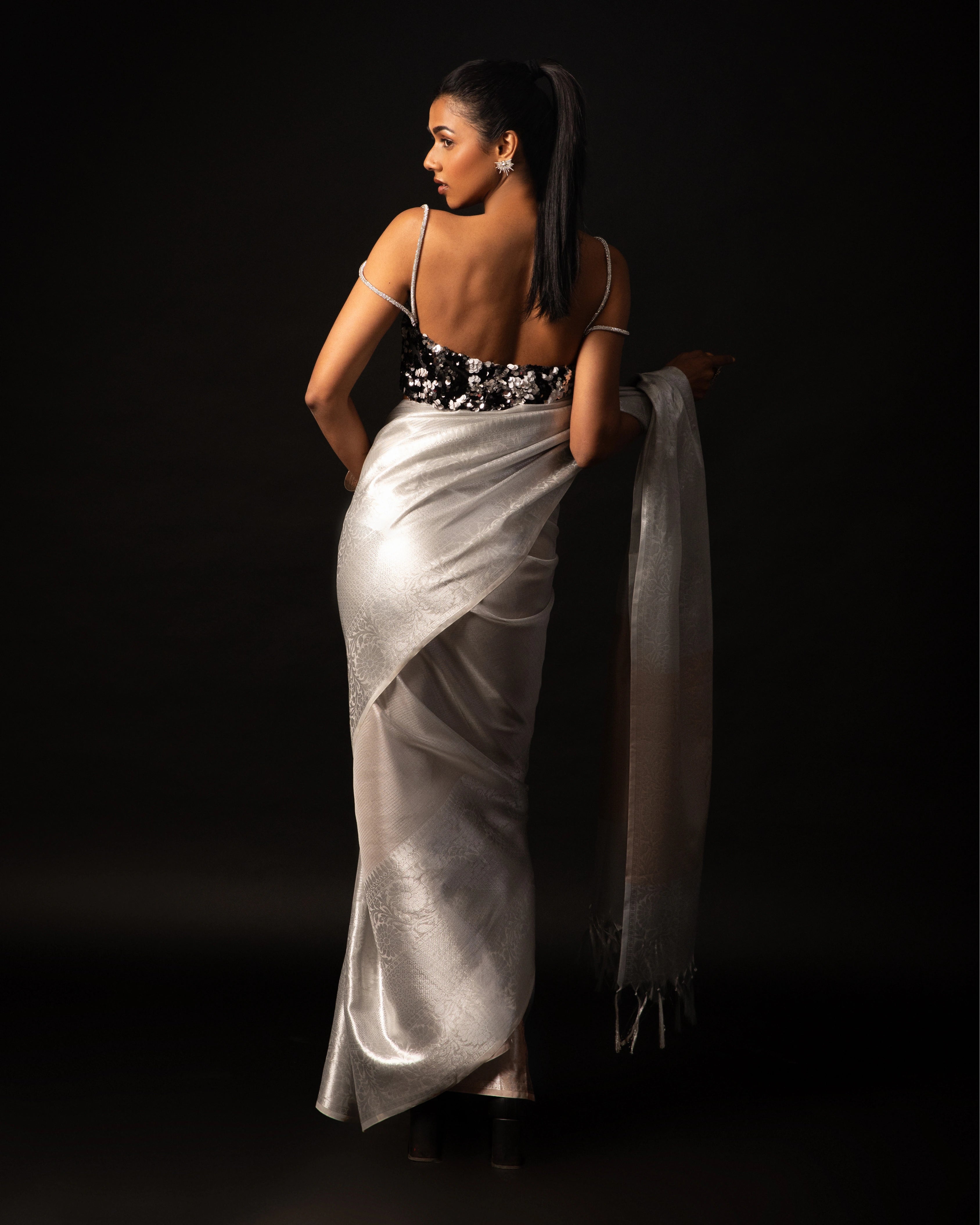 White Banarsi Silk Blend Metallic Tone Saree with Handwoven Border and Black Floral Sequin Blouse